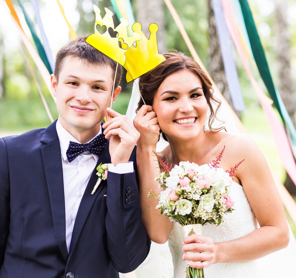 Wedding Photo Booth Rental Social Serve wedding couple posing with crown, mask